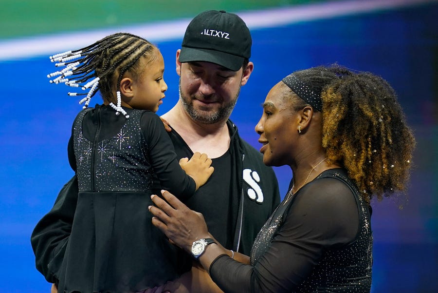 Serena Williams, of the United States, talks with her daughter Olympia and husband Alexis Ohanian after defeating Danka Kovinic, of Montenegro, during the first round of the US Open tennis championships, Monday, Aug. 29, 2022, in New York. (AP Photo/Charles Krupa)