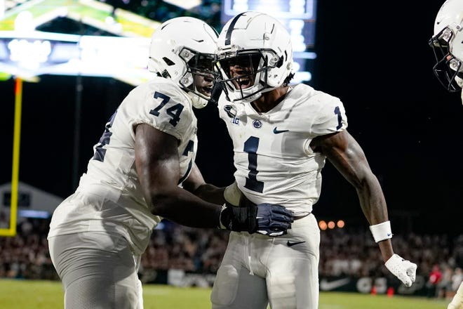Penn State wide receiver KeAndre Lambert-Smith (1) celebrates a touchdown with offensive lineman Olumuyiwa Fashanu (74) during the second half of the team's NCAA college football game against Purdue in West Lafayette, Ind., Thursday, Sept. 1, 2022. (AP Photo/Michael Conroy)