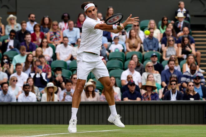 Switzerland's Roger Federer plays a return to Britain's Cameron Norrie during the men's singles third round match on day six of the Wimbledon Tennis Championships in London, Saturday, July 3, 2021.