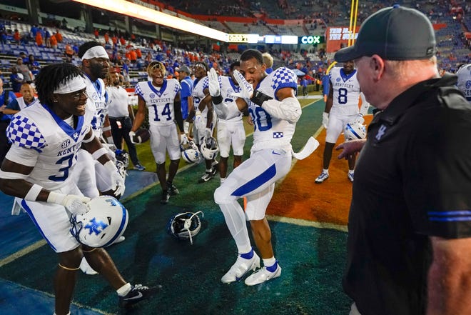 Kentucky coach Mark Stoops, right, watches his players dance in celebration after defeating Florida in an NCAA college football game Saturday, Sept. 10, 2022, in Gainesville, Fla. (AP Photo/John Raoux)