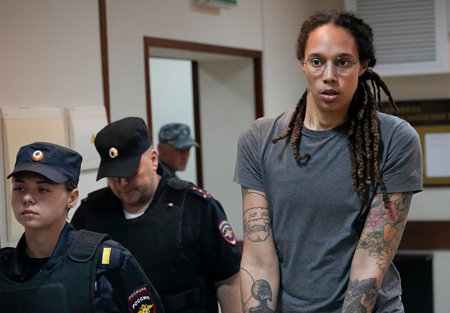 WNBA star and two-time Olympic gold medalist Brittney Griner is escorted from a courtroom after a hearing outside Moscow in August.