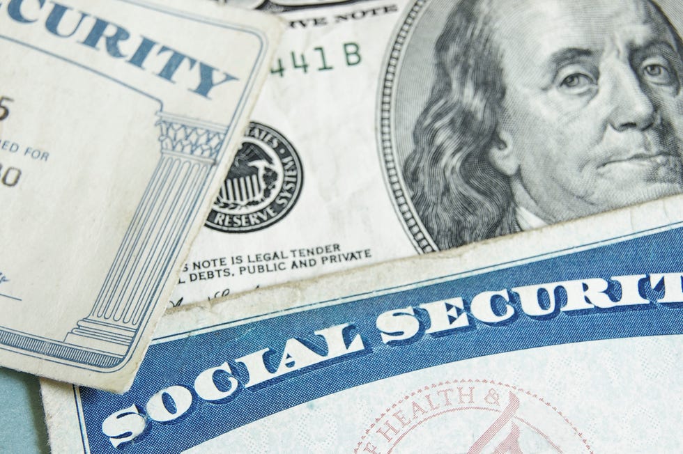 Social Security card on top of a hundred dollar bill.