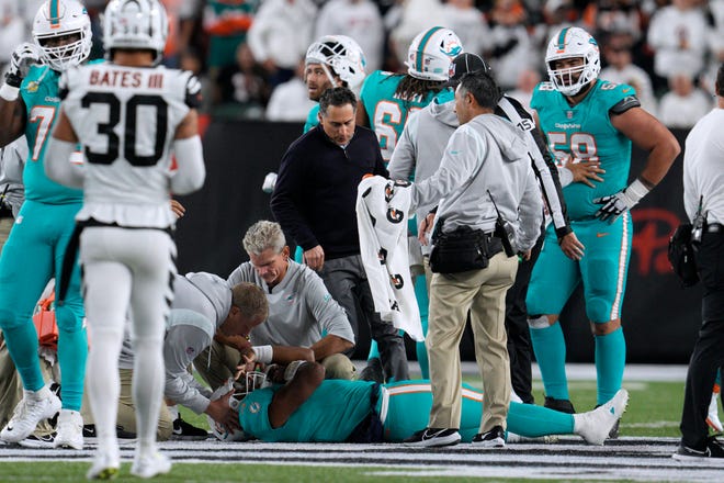 Dolphins quarterback Tua Tagovailoa is examined during Thursday night's game against the Bengals.