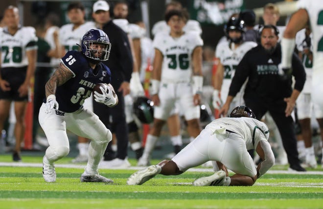 Nevada running back Toa Taua (35) carries against Hawaii during the first half of an NCAA college football game Saturday, Oct. 15, 2022, in Honolulu. (AP Photo/Marco Garcia)