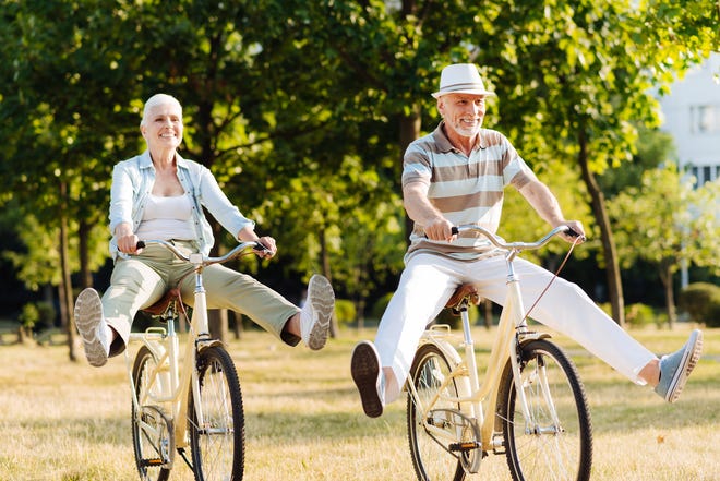 Retired couple enjoying a bike ride.