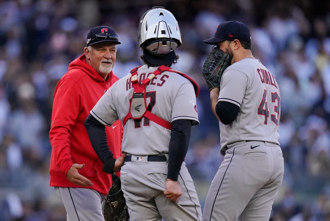 Cleveland Guardians pitching coach Carl Willis, left, talks with catcher Austin Hedges (17) and pitcher Aaron Civale during the first inning of Game 5 of an American League Division baseball series against the New York Yankees, Tuesday, Oct. 18, 2022, in New York. (AP Photo/Frank Franklin II)