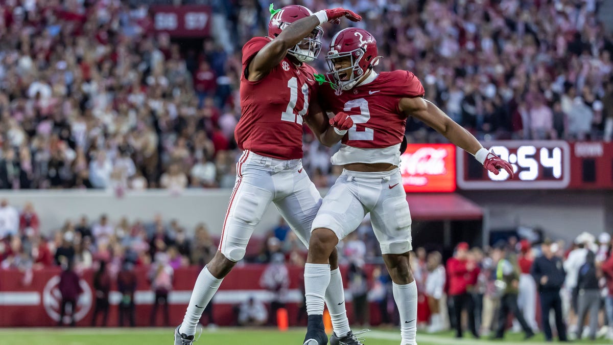 Alabama wide receiver Traeshon Holden (11) and running back Jase McClellan (2) celebrate after Holden's touchdown during the first half against Auburn, Saturday, Nov. 26, 2022, in Tuscaloosa, Ala.
