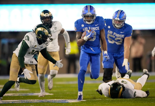 Air Force wide receiver DeAndre Hughes, center, breaks for a long gain as Colorado State defensive back Greg Laday, left, and defensive lineman Marshon Oxley pursue in the second half of an NCAA college football game Saturday, Nov. 19, 2022, at Air Force Academy, Colo. (AP Photo/David Zalubowski)