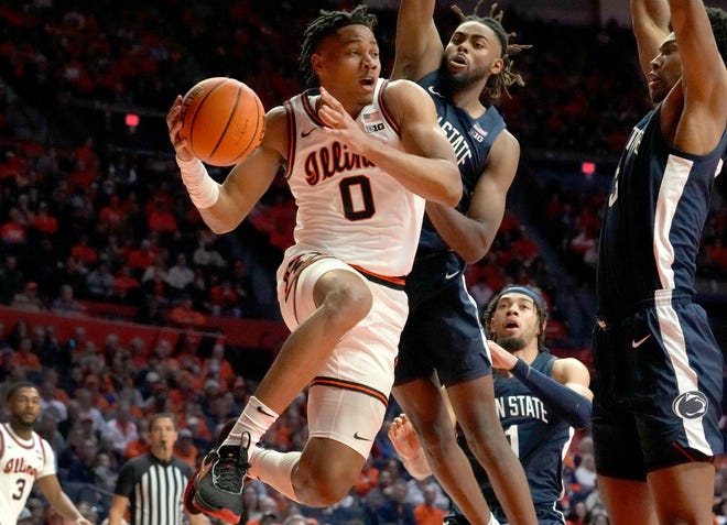 Illinois forward Terrence Shannon Jr. (0) looks to pass under pressure from Penn State's Evan Mahaffey, center, and Kebba Njie during the first half of their game Saturday, Dec. 10, 2022, in Champaign, Ill.