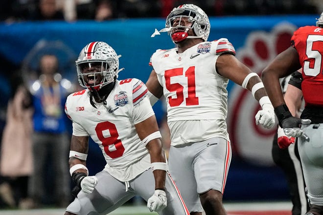 Ohio State defensive end Javontae Jean-Baptiste (8) and Ohio State defensive tackle Michael Hall Jr. (51) react to a sack on Georgia during the second half of the Peach Bowl NCAA college football semifinal playoff game, Saturday, Dec. 31, 2022, in Atlanta. (AP Photo/John Bazemore)