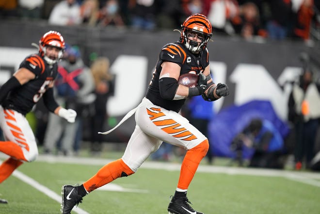 Cincinnati Bengals defensive end Sam Hubbard returns a fumble by Baltimore Ravens quarterback Tyler Huntley 98 yards for a touchdown in the second half of an NFL wild-card playoff football game in Cincinnati on Sunday.