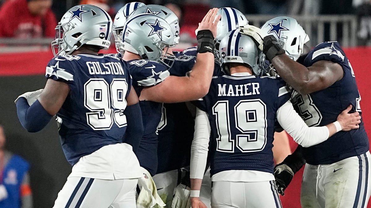 Brett Maher is congratulated after his extra point attempt finally finds its mark against the Tampa Bay Buccaneers.