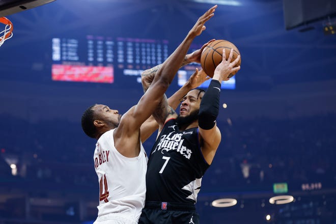 Los Angeles Clippers guard Amir Coffey (7) shoots against Cleveland Cavaliers forward Evan Mobley (4) during the first half of an NBA basketball game, Sunday, Jan. 29, 2023, in Cleveland. (AP Photo/Ron Schwane)