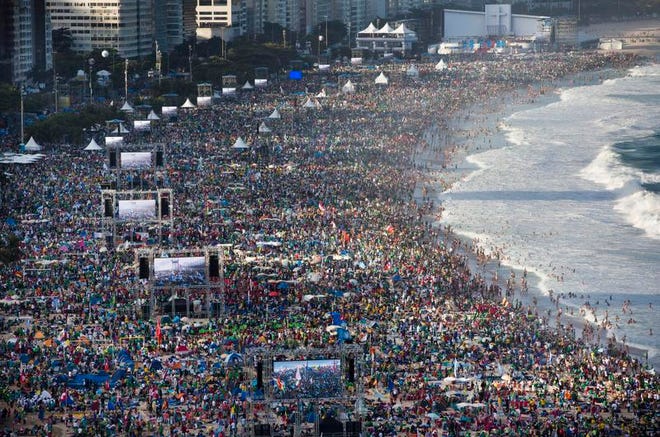 In this file photo taken on July 27, 2013, pilgrims and residents gather on Copacabana beach before the arrival of Pope Francis for World Youth Day in Rio de Janeiro, Brazil.