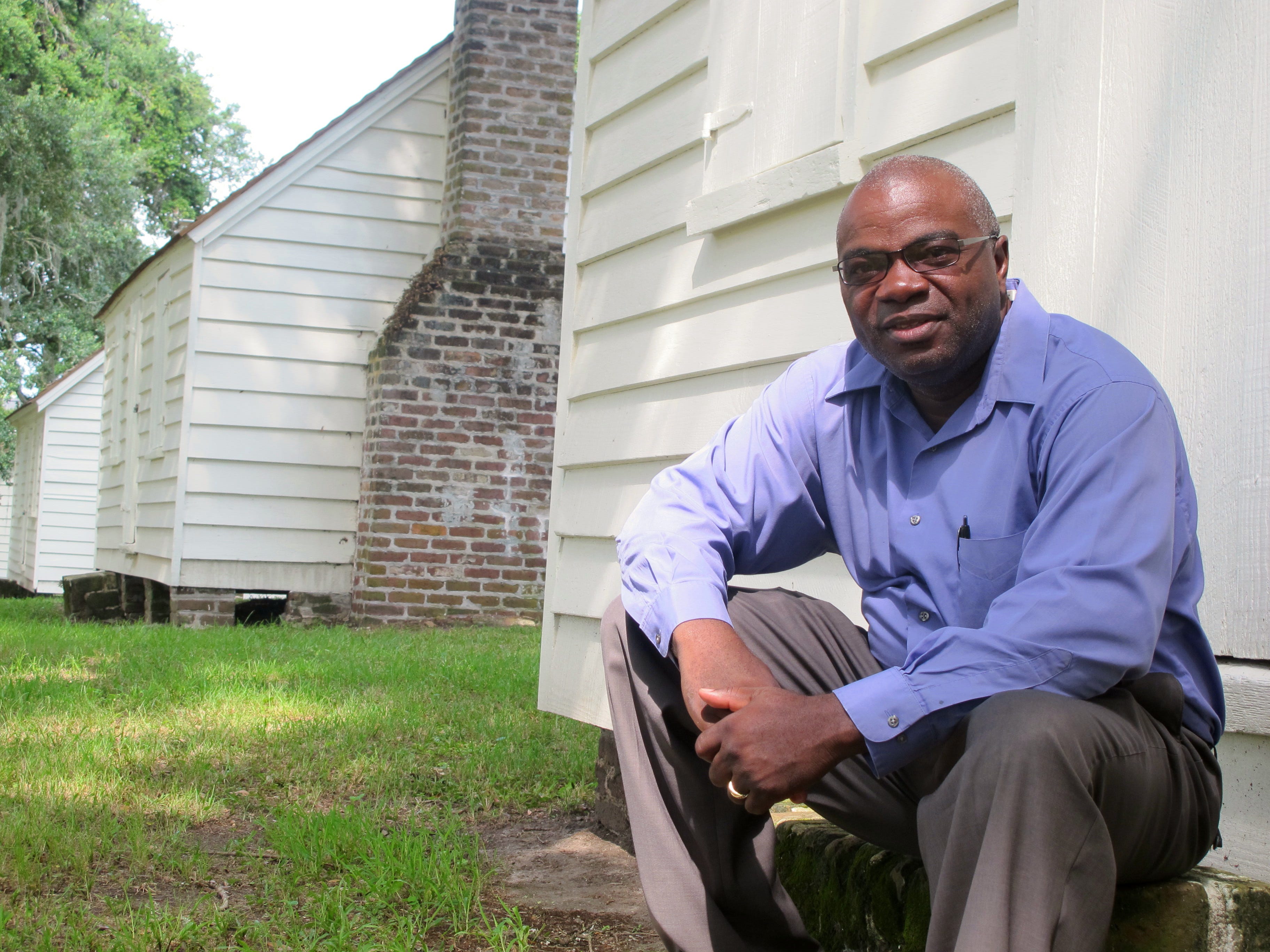 Joe McGill of the National Trust For Historic Preservation sits outside one of the slave cabins at McLeod Plantation in Charleston, S.C. As part of the Slave Dwelling Project, McGill has slept in old slave dwellings in a dozen states during the past three years.