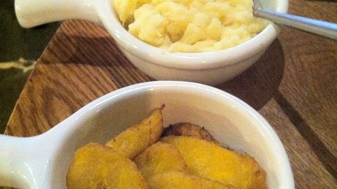 Mashed potatoes, top, have a smooth but chunky consistency with a lovely sour note. The fried plantains are heavily saturated in oil.