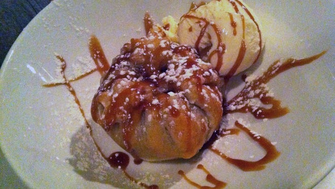 The apple dumpling features a whole apple baked with sugar and spices in a purse of puff pastry then drizzled with sweet caramel and creamy vanilla ice cream. The pastry exterior could be a bit thinner and flakier.