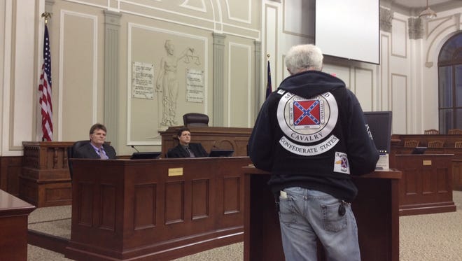 Confederate flag supporter Larry Bradley, wearing a representation of the Confederate battle flag on his sweatshirt, talks to  Haywood County commissioners Monday night in Waynesville, N.C.