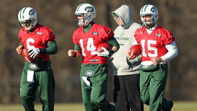 New York Jets quarterbacks Mark Sanchez (6), and Greg McElroy (14) and Tim Tebow (15) run past head coach Rex Ryan during practice at the Jets training facility on Wednesday, Dec. 19, 2012.