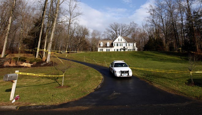 A police cruiser sits in the driveway as crime scene tape surrounds the home of Nancy Lanza on Dec. 18 in Newtown, Conn.