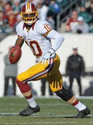 Washington Redskins quarterback Robert Griffin III (10) looks for a receiver during second quarter action against the Philadelphia Eagles at Lincoln Financial Field in Philadelphia on Dec. 23, 2012.