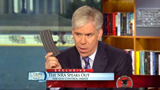 NBC News reporter David Gregory displays what he described as a high-capacity ammunition magazine on 'Meet the Press.'