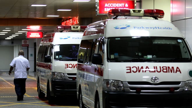 Ambulances are parked outside the accident and emergency entrance at Mount Elizabeth Hospital in Singapore, late Friday.