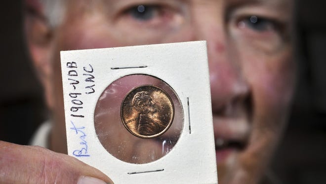 Coin collector Cy Schaefer has had a passion for pennies ever since his brother got an Indian head penny in change for a pack of cigarettes as a young man in the 1940s. Here he shows an uncirculated 1909 VDB penny, the first year of the Lincoln penny designed by Victor David Brenner. The penny has the initials of the designer on its reverse side - a feature that was soon taken off.