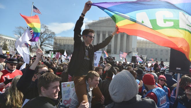 Same-sex marriage supporters demonstrate outside the Supreme Court on Wednesday.