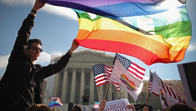 Eric Breese, left, of Rochester, N.Y., demonstrates outside the U.S. Supreme Court on Wednesday with other same-sex marriage supporters.