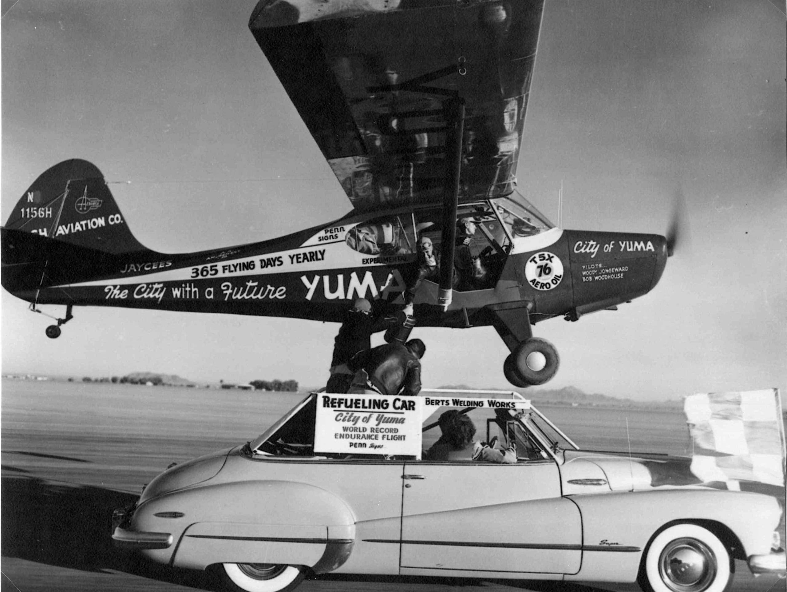 Bob Hodge, in the speeding Buick,  hands breakfast and lunch to Bob Woodhouse in an Aeronca Sedan flying low over a Yuma, Ariz. airstrip in 1949.