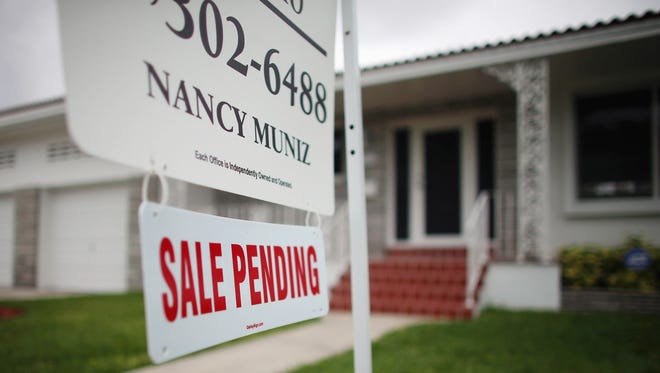 A "Sale Pending" sign in front of a Miami home in April.