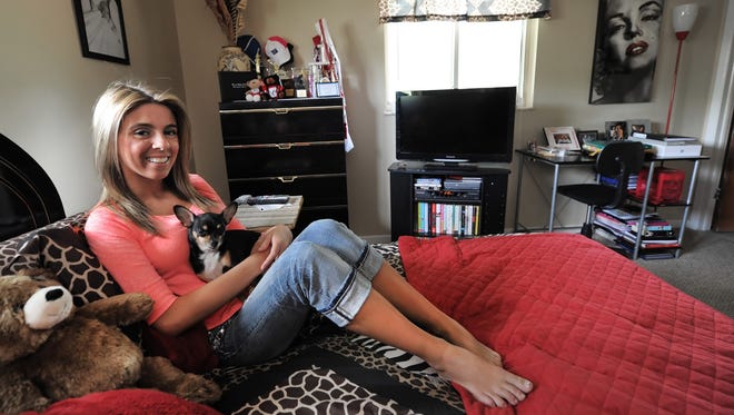 Paige Rawl, 18 of Indianapolis, sits in her bedroom with her dog on June 20. She is a top five finalist with Seventeen magazine as part of their Pretty Amazing Contest.