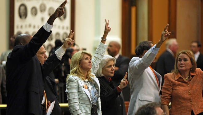 State Sen. Wendy Davis, third from left, votes against an anti-abortion bill at the Texas Senate in Austin. Davis became an online star attempting to filibuster the bill.