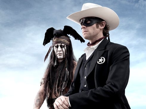 Johnny Depp, left, as Tonto, a spirit warrior on a personal quest, joins forces in a fight for justice with Armie Hammer, as John Reid, a lawman who has become a masked avenger, The Lone Ranger, in 'The Lone Ranger.'