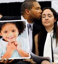 Jimmy Greene and Nelba Márquez-Greene with a portrait of their daughter, Ana, who was killed Dec. 14.