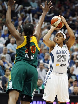 Lynx forward Maya Moore (23), shooting over Storm forward Camille Little, scored 20 points to help the Lynx squeak out a 73-72 win in the decisive Game 3.