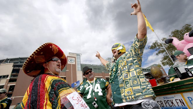 Andrew Tellez, left, and Lannon Turowski, right, both of San Diego enjoy tailgating before the start of the game Sept. 9 in Green Bay, Wis.
