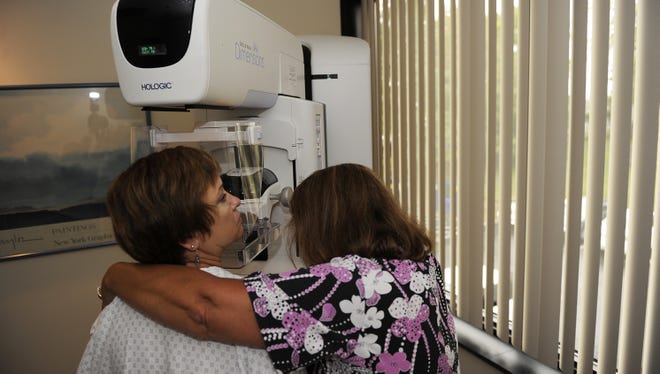 Barbara Pritchyk is positioned by a technician for a 3-D mammogram screening called tomosynthesis Sept. 18 at Washington Radiology Associates in Fairfax, Va.