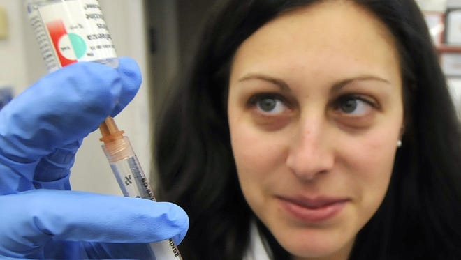 Pharmacist Crystal Dibella prepares a flu inoculation Jan. 3 at a CVS pharmacy in High Point, N.C. 