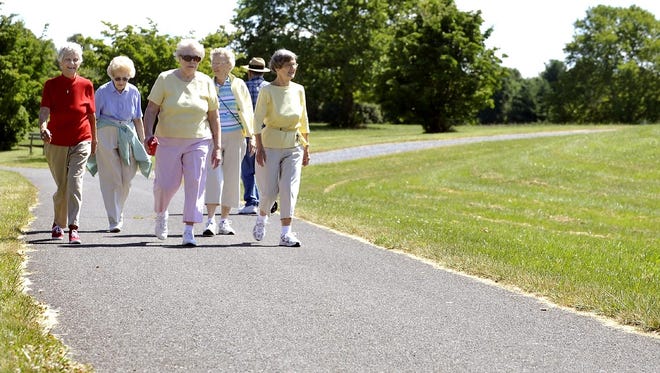 A group of seniors walk at Louise Moore Park in Nazareth, Pa. Such exercise might help prevent brain shrinkage, new research suggests. (AP Photo/The Express-Times, Bill Adams)