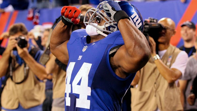 The New York Giants promise to flex their muscles Sunday in a rematch with the Dallas Cowboys. Here, running back Ahmad Bradshaw reacts after scoring a touchdown in the Week 1 meeting, won by the Cowboys 24-17