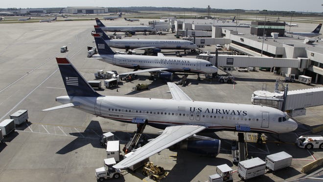 In this Sept. 27, 2012 photo, US Airways jets are parked at Charlotte/Douglas International Airport.