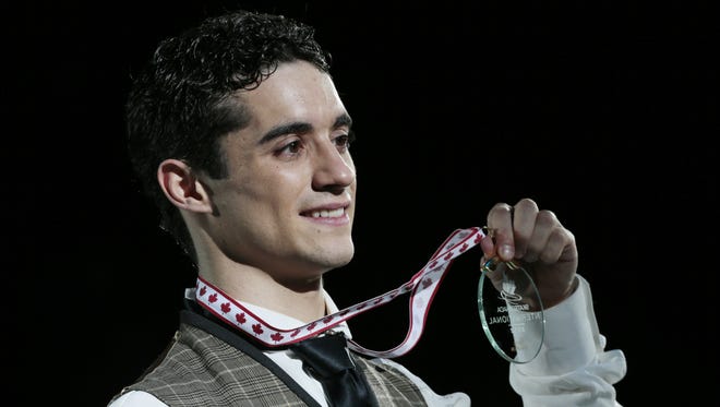 Gold medalist Javier Fernandez of Spain shows off his medal during the victory ceremony.