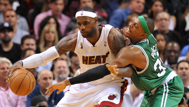 Heat forward LeBron James posts up Celtics forward Paul Pierce in Tuesday's season-opening win.
