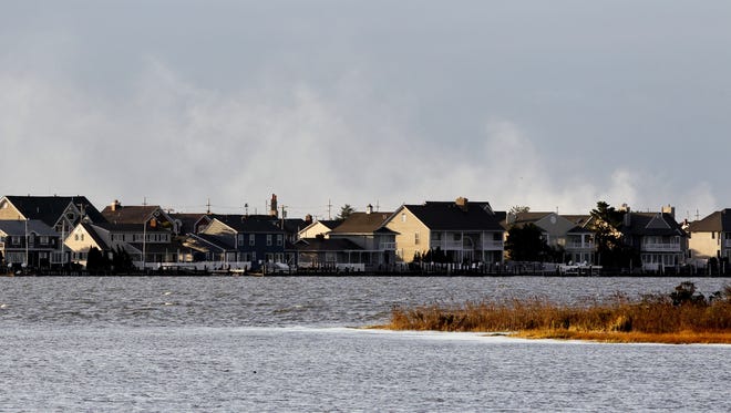 Smoke from early morning fires today on Mantoloking, N.J., blows in the air following the presence of superstorm Sandy.