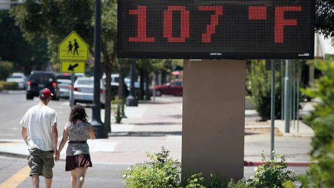 The sign at the Clovis Memorial District building reads 107 degrees on Aug. 10 in Clovis, Calif. Temperatures soared into triple digits across the western United States.