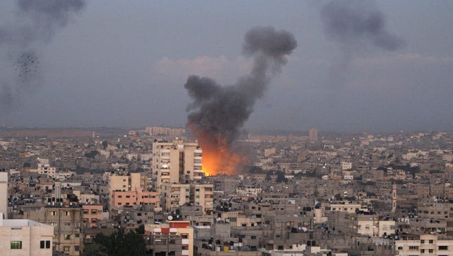 Columns of smoke rise following an Israeli airstrike in Gaza City on Wednesday.