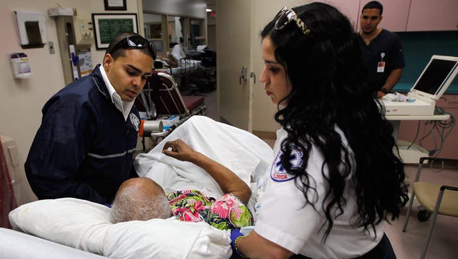 Paramedics treat a patient in a Miami emergency room.
