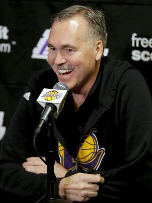 Lakers coach Mike D'Antoni speaks with news reporters before making his season debut Tuesday against the Nets.